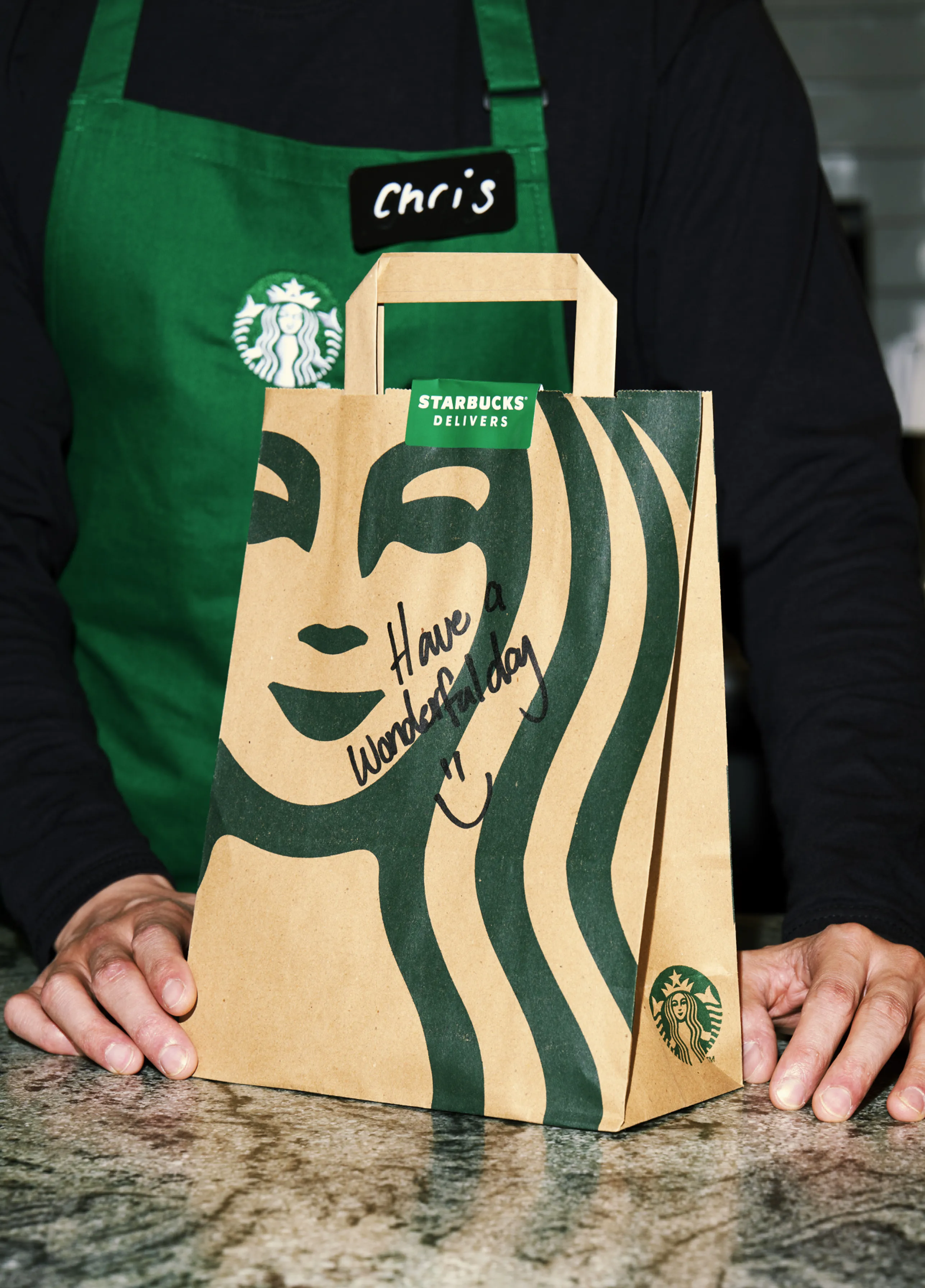 A Starbucks Partner with a delivery bag